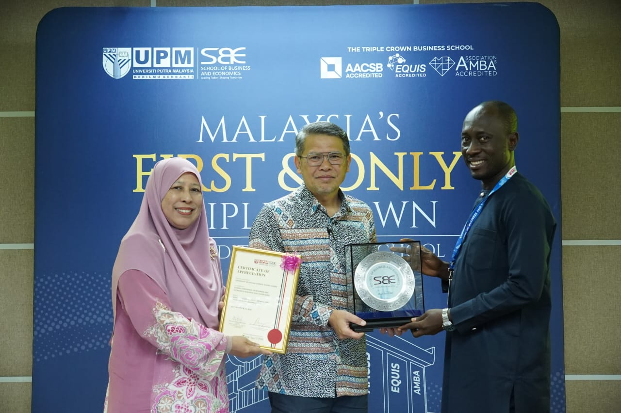 Prof. Owusu receiving his awards at the GCBER 2026